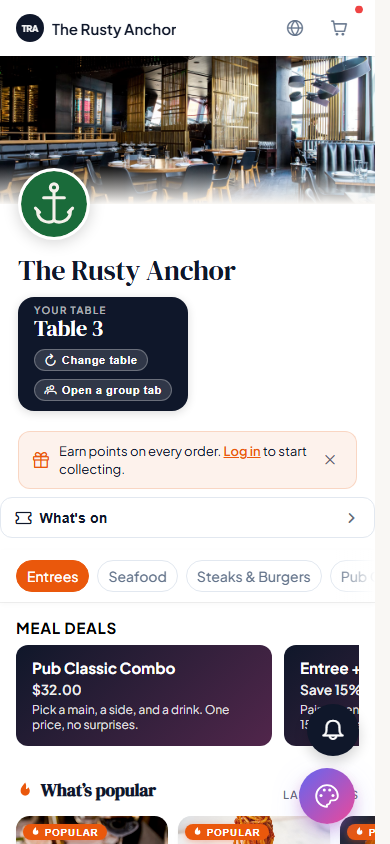The diner-facing menu on a phone, showing the venue banner, the table label, category tabs, meal deals and popular items.